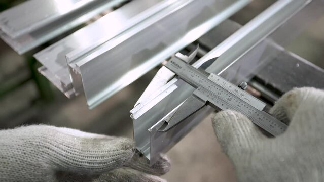 Precision Measurement of Metal Workpiece Using Vernier Caliper in Industrial Setting
