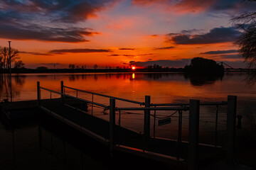 Fototapeta premium Winter sunset with reflections near Metten, Danube, Deggendorf, Bavaria, Germany