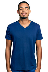 Young african american man wearing casual t shirt with a happy and cool smile on face. lucky person.