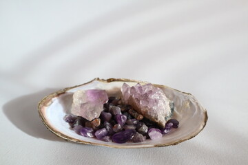 Amethyst druse and amethyst kiesel in shell on the table.