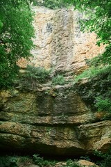 Traces of a dried-up waterfall flowing along the cliff. Mountain landscape