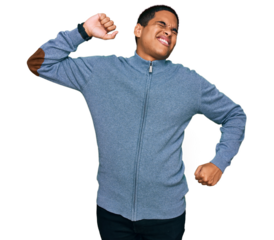 Young handsome hispanic man wearing casual sweatshirt stretching back, tired and relaxed, sleepy and yawning for early morning