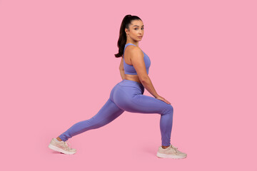 Woman in fitness clothing performing a lunge