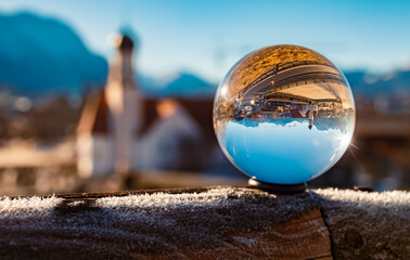 Crystal ball alpine winter landscape shot with a church at Wallgau, Garmisch-Partenkirchen,...