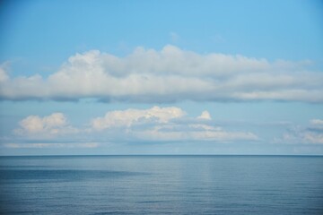 Water and sea or ocean and clouds above the water surface