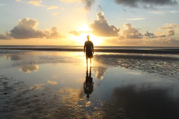  silhueta de homem em nascer do sol na praia de tatuamunha, alagoas  © carina furlanetto