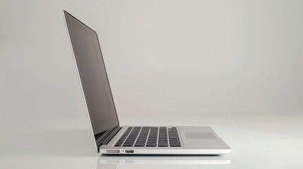 A sleek silver laptop sitting open on a minimalist desk against a pristine white backdrop