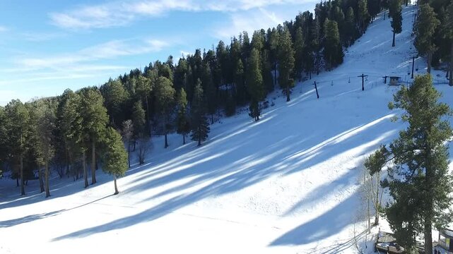 Drone of Mount Lemmon while it is covered with snow and pine trees forest on it in Arizona, US