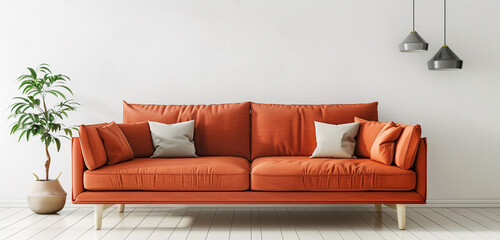 Rustic coral-orange sofa bringing comfort to a Scandinavian living space with a clean white wall.