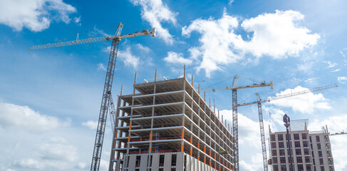 Panorama view concrete building and working crane under construction, high-rise hotels, office building, skyscraper structure with precast concrete wall in Irving, Texas, commercial real estate