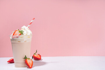 Strawberry milkshake or smoothie, summer fruit cocktail with fresh strawberries, on white pink...