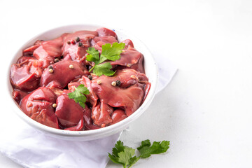 Raw chicken, turkey, duck, poultry liver with herbs and spices. Poultry liver dinner cooking background, diet food copy space - 774894098