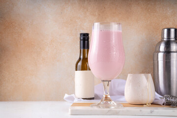 Espanhola Drink, condensed milk and red wine spanish cold cocktail with wine bottle and condensed milk  on table, copy space
