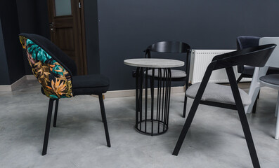 Gray wooden table combined with dark gray and black wooden chairs with soft fabric upholstery