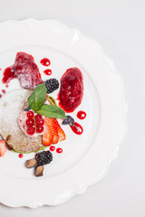 Fresh and Healthy Breakfast with Pancakes, Fruits, and Berries on White Plate