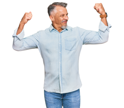 Middle age grey-haired man wearing casual clothes showing arms muscles smiling proud. fitness concept.