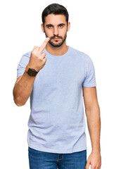 Young hispanic man wearing casual clothes showing middle finger, impolite and rude fuck off...