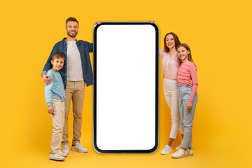 Family with large smartphone mockup on yellow background