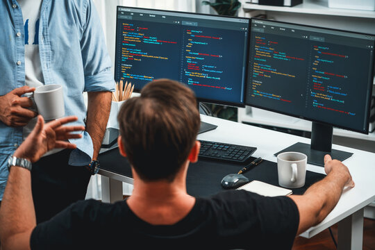 IT developers discussing online software development information on pc screen, creating program coding for latest version application on website. Concept of brainstorming firmware updated. Sellable.