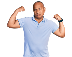Hispanic middle age man wearing casual t shirt showing arms muscles smiling proud. fitness concept.
