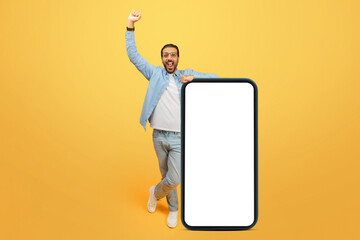 Excited man with oversized smartphone