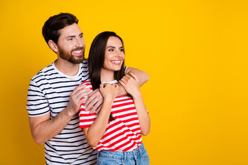 Photo portrait of lovely young couple hugging look empty space wear trendy striped garment isolated...