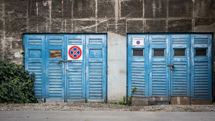 blue wooden garage door no stopping no parking sign