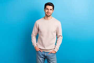 Photo of cheerful good mood man with stylish haircut dressed beige pullover hold arms in pockets...