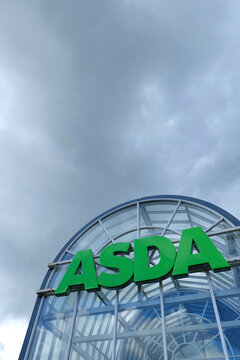 ASDA supermarket entrance in Carlisle, UK with grey skies looming behind.
