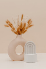 Stylish still life composition. Ceramic vase with bunny tail and pampas grass bouquet, scandinavian...