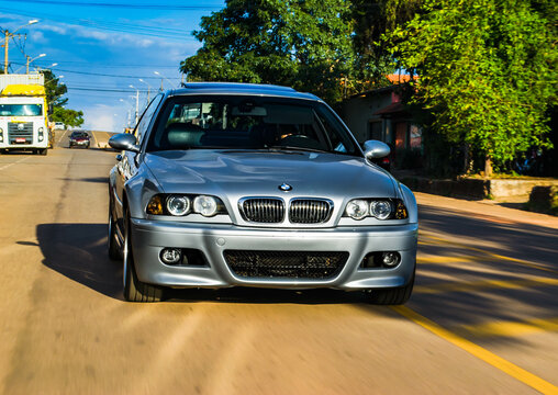 Rolling shot of a silver BMW M3 E46 on a sunny day - High Resolution Image