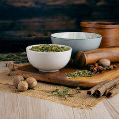 FENUGREEK LEAVES - METHI on wooden table background. Herbs, spices and dried food baking ingredient. Mortar and different spices. Cottage kitchen. Product Photography