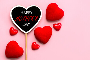 Happy Mother's Day. Wooden heart with the text Happy Mother's Day with red hearts