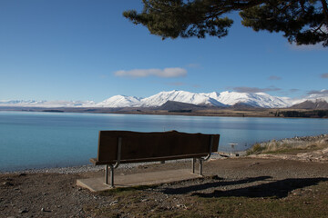 Park bench along the foreshore of a mountain lake