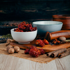 MORUGA SCORPION CHILLI PODS on wooden table background. Herbs, spices and dried food baking...