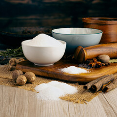 Mono-sodium Glutamate Powder MSG on wooden table background. Herbs, spices and dried food baking...