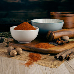 NAGA GHOST CHILLI POWDER on wooden table background. Herbs, spices and dried food baking...