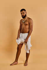A bearded man stands confidently, draped in a white towel. His gaze is determined, exuding a sense...
