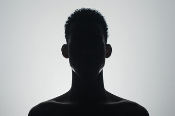A dark silhouette figure of a man on white background, with unclear face feature - obrazy, fototapety, plakaty