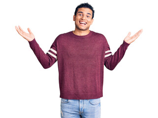 Hispanic handsome young man wearing casual clothes celebrating crazy and amazed for success with...