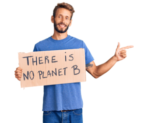 Handsome blond man with beard holding there is no planet b banner smiling happy pointing with hand and finger to the side