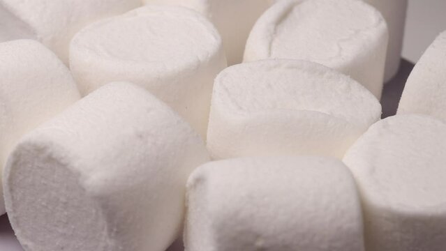white marshmallow, rotation in circle. marshmallow for cocoa or for grilling, Turning. selective focus. view from above.	