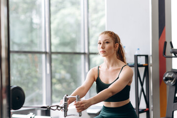 Fototapeta premium woman trains in fitness gym