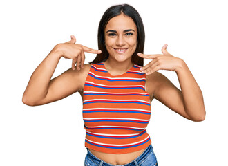Young brunette woman wearing casual clothes smiling cheerful showing and pointing with fingers teeth and mouth. dental health concept. - obrazy, fototapety, plakaty