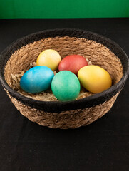 colorfully painted eggs in a wicker basket easter idea