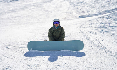 Fototapeta na wymiar Snowboarder Contemplating on the Slopes