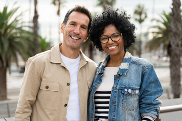 Portrait of 40 years smiling friends - African American woman and caucasian man couple 