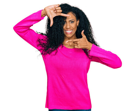 Middle age african american woman wearing casual clothes smiling making frame with hands and fingers with happy face. creativity and photography concept.