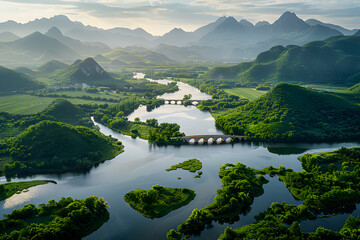 an aerial view of a river surrounded by mountains and greenery, with a bridge in the middle of the river and a bridge in the middle of the river.