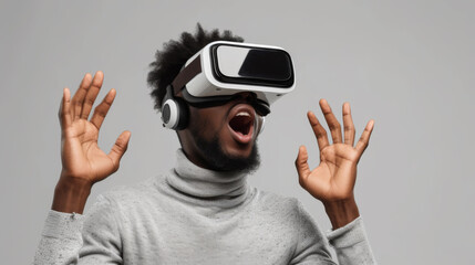 A man wearing a virtual reality headset is reacting with excitement, his hands raised and mouth open in amazement.